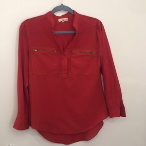 Romantic red long-sleeve blouse.